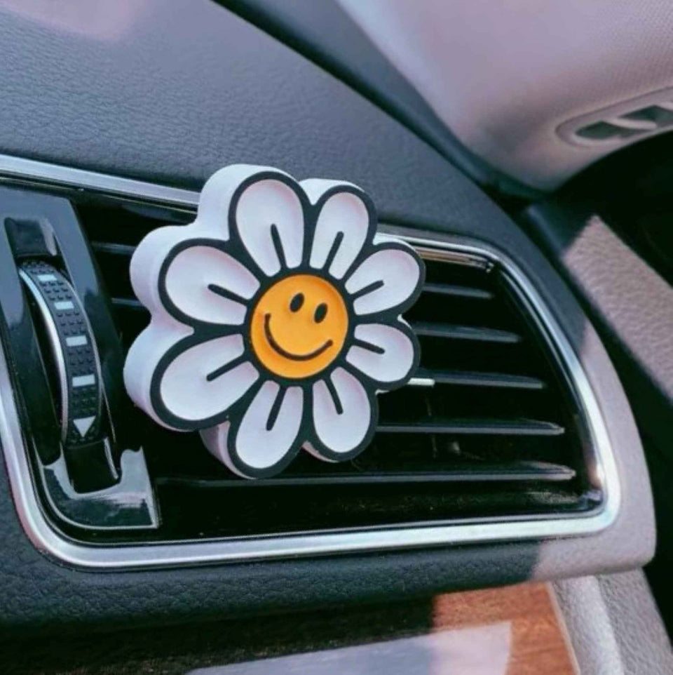 Yellow smiley face vent accessory with flower scent pad