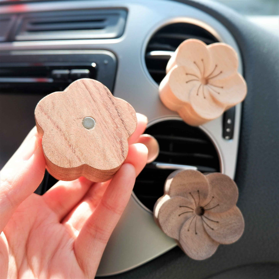 Close-up of plum blossom wooden car vent clips with floral details
