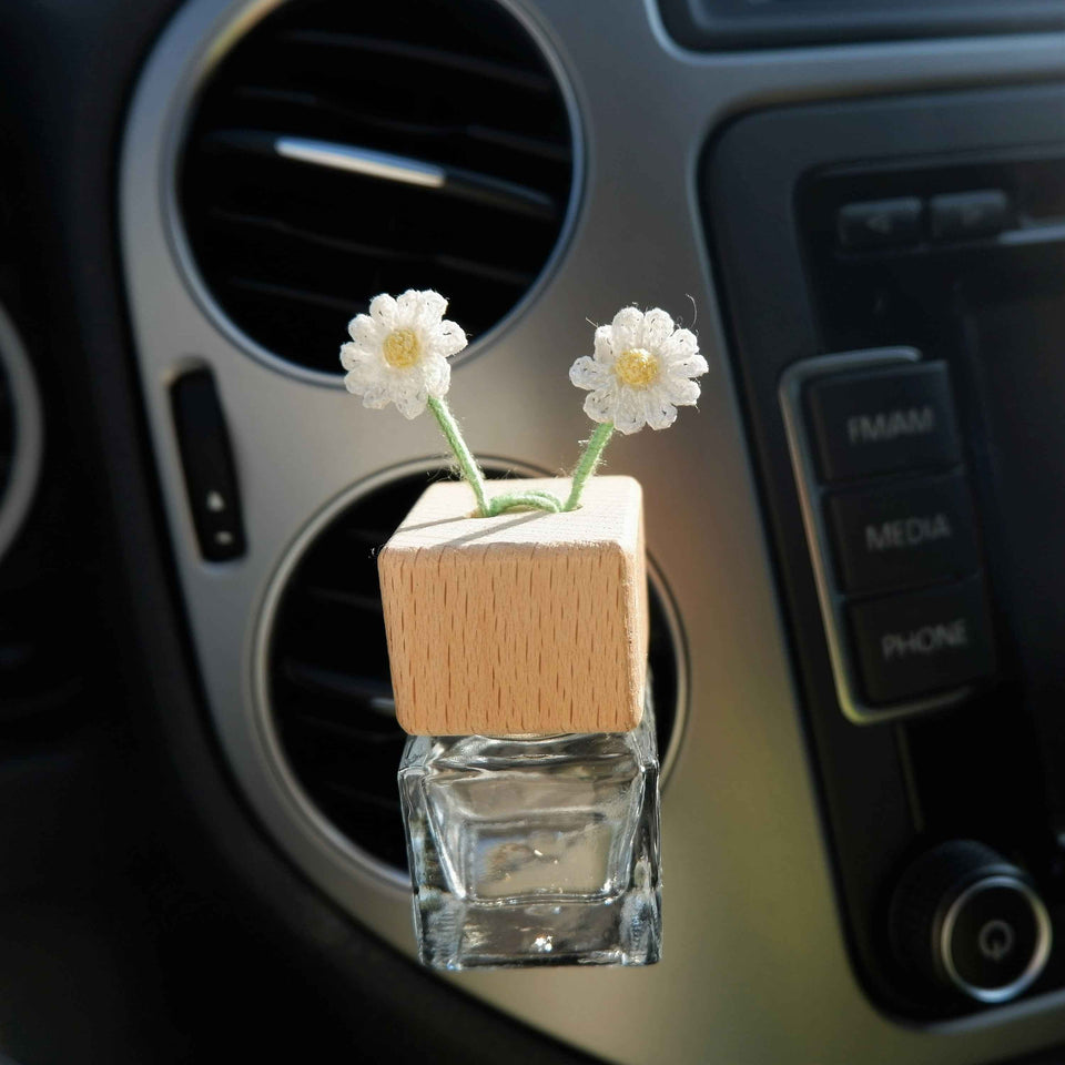 Cute floral car fragrance bottle clipped to air vent