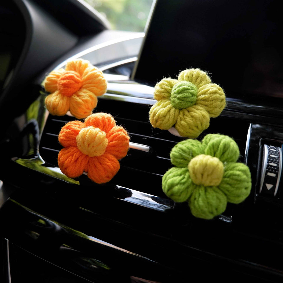 Fluffy yarn flower car air freshener vent clip close-up
