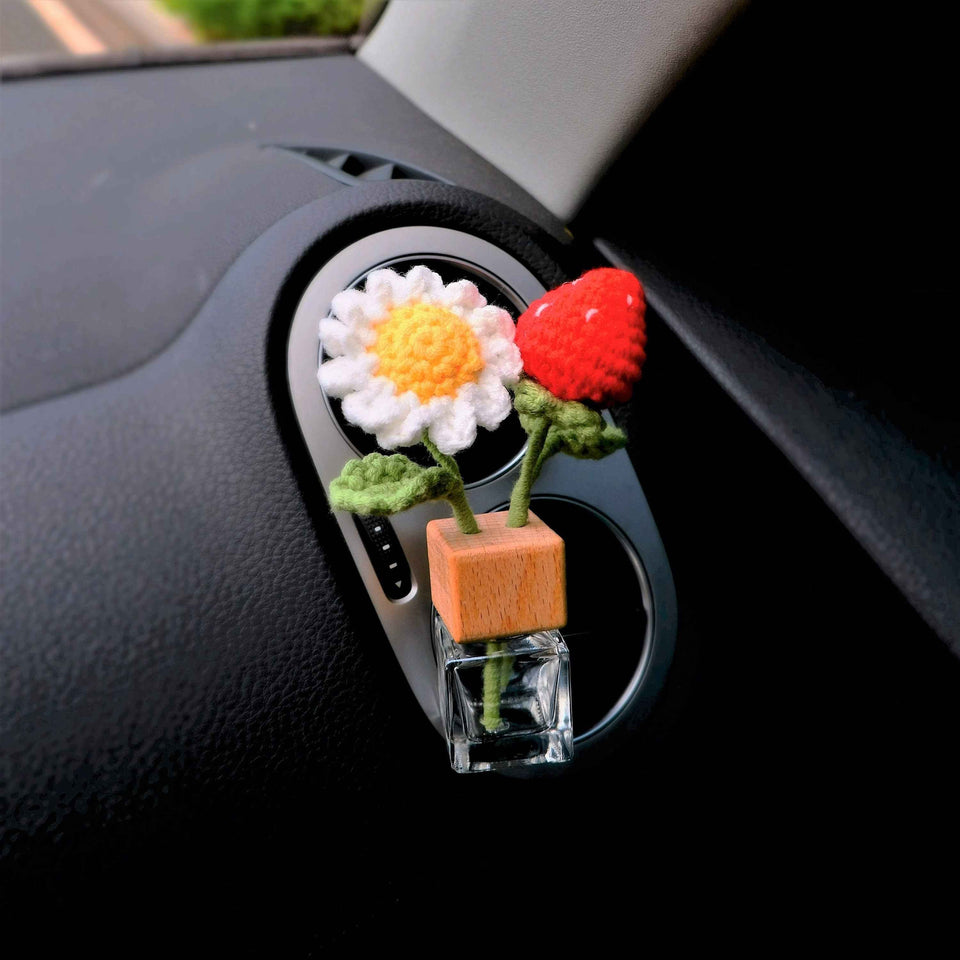 Strawberry daisy car air freshener bottle clipped to car vent