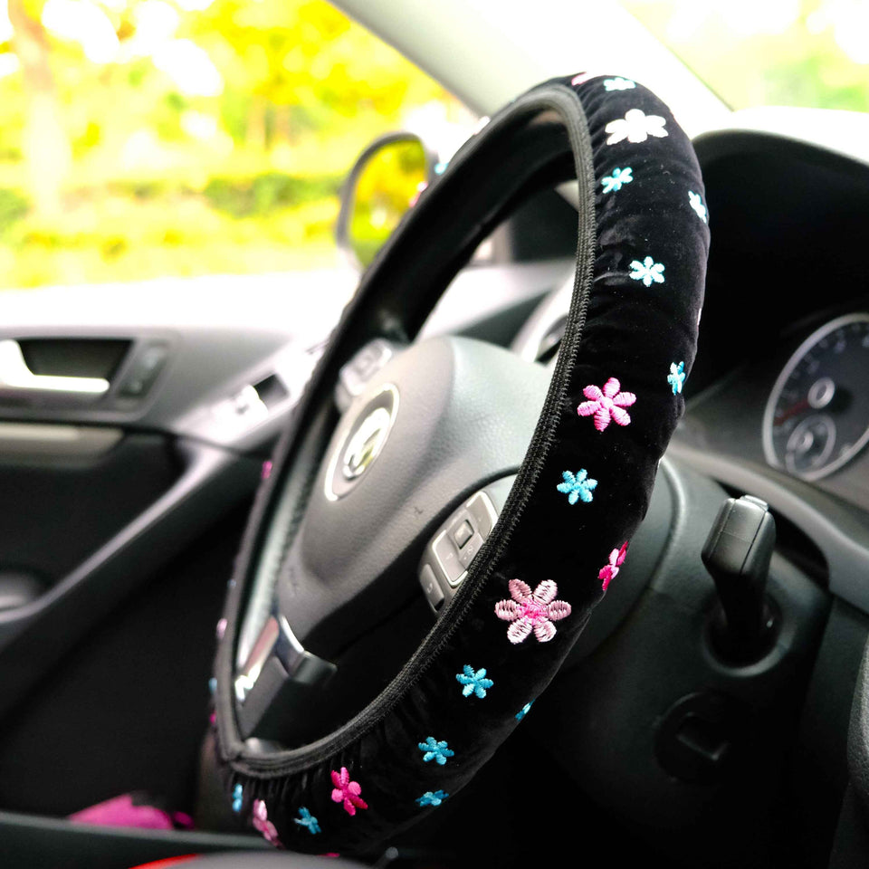 Pink floral steering wheel cover installed on car interior