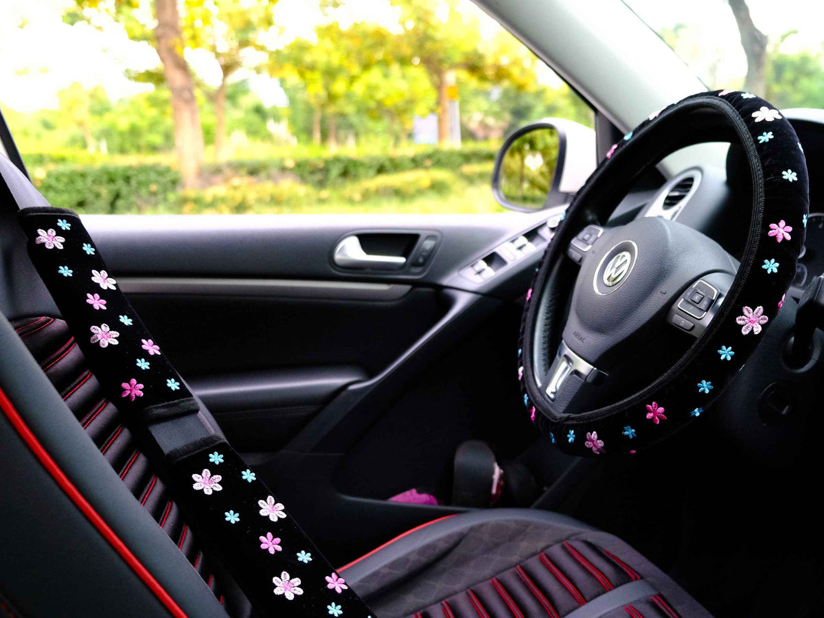 Close-up of pink flower embroidery on steering wheel cover
