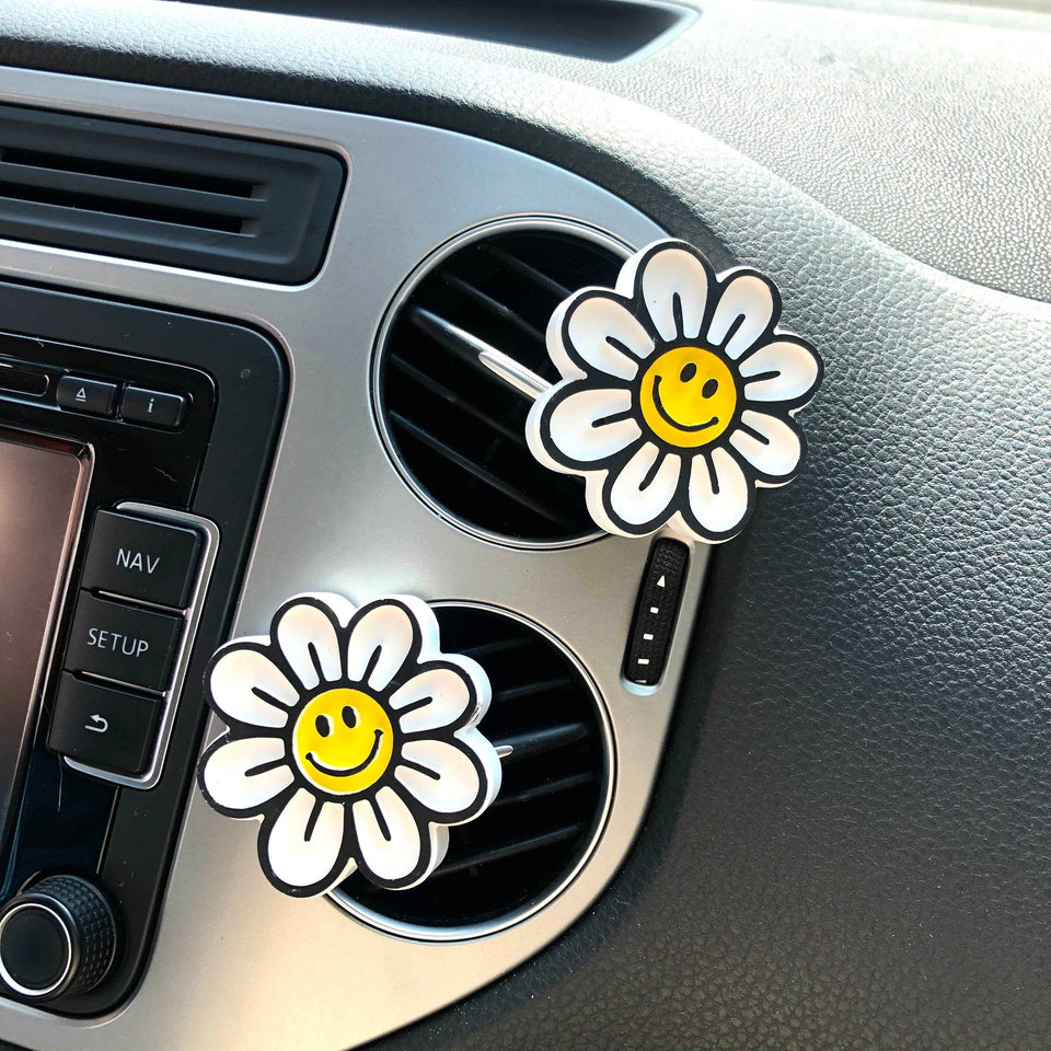 Smiley face and daisy car vent clips with cheerful flower design