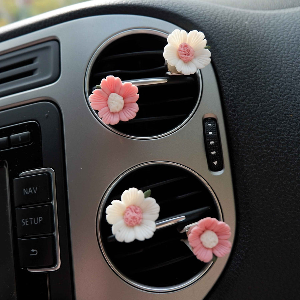 Close-up of handmade clay sakura car vent clips for cute car interior